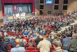 Some 1,200 men kneel in prayer during a Mass on Feb. 18 at East Central High School in St. Leon that was part of the eighth annual E6 Catholic Men&rsquo;s Conference sponsored by All Saints Parish in Dearborn County. (Photo by Sean Gallagher)
