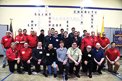Seminarians from Bishop Simon Brut&eacute; College Seminary in Indianapolis, accompanied by Father Joseph Moriarty, the seminary&rsquo;s rector, pose with members of Saint Thomas More Knights of Columbus Council 7431 after a March 27 dinner to support vocations to the priesthood, diaconate and religious life at St. Thomas More Parish in Mooresville. The Knights organized the dinner. (Photo by Sean Gallagher)
