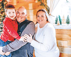 Jessica and Kevin Murphy smile with their son Daniel in December 2022. She was recently named one of Terre Haute&rsquo;s &ldquo;12 Under 40&rdquo; professionals who have made significant contributions to the community. (Submitted photo)