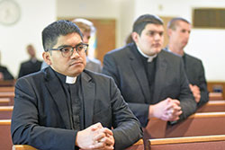 Then-seminarian Jos&eacute; Neri, left, kneels in prayer on Aug. 9, 2021, in the chapel of Our Lady of Fatima Retreat House in Indianapolis. Neri. who was ordained a transitional deacon in 2022, will be ordained a priest for the archdiocese on June 3 at SS. Peter and Paul Cathedral in Indianapolis. (Criterion file photo by Sean Gallagher)