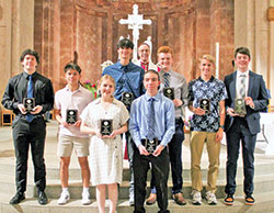 Archbishop Charles C. Thompson poses for a photo with recipients of the Spirit of Youth Award from the archdiocese&rsquo;s Catholic Youth Organization (CYO). The youths were honored during the CYO&rsquo;s Volunteers Awards Ceremony at SS. Peter and Paul Cathedral in Indianapolis on May 2. (Photo by Michaela Ward of the CYO)