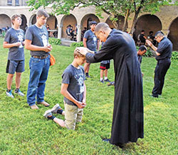 Actress Laura Linney (left) stars wRoman Caito, a member of St. Michael Parish in Greenfield, kneels on June 26 in the courtyard of Bishop Simon Brut&eacute; College Seminary in Indianapolis to receive a blessing from newly ordained Father Jack Wright during Bishop Brut&eacute; Days, the annual vocations camp of the archdiocesan vocations office. Newly ordained Father Jos&eacute; Neri, right, joined Father Wright in offering blessings to lines of camp participants. (Photo by Sean Gallagher)ith the legendary Dame Maggie Smith (right) in the film The Miracle Club, which centers around four women&rsquo;s trip to Lourdes, France. (Photo courtesy of Sony Pictures)