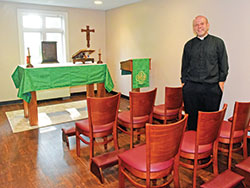 Father Andrew Syberg stands on Aug. 1 in a new chapel for first-year seminarians at Bishop Simon Brut&eacute; College Seminary in Indianapolis. (Photo by Sean Gallagher)