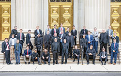 Archbishop Charles C. Thompson and archdiocesan director of seminarians Father Eric Augenstein pose on Aug. 15 on the front steps of SS. Peter and Paul Cathedral in Indianapolis with 31 of the archdiocese&rsquo;s 32 seminarians. (Submitted photo by Holly Dexter)