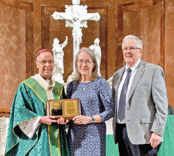 Mary and Larry Dougherty, members of Immaculate Heart of Mary Parish in Indianapolis, receive the archdiocese&rsquo;s Archbishop Edward T. O&rsquo;Meara Respect Life Award from Archbishop Charles C. Thompson during the annual Respect Life Mass at SS. Peter and Paul Cathedral in Indianapolis on Oct. 1. (Photo by Natalie Hoefer)