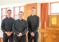Seminarians Isaac Siefker, left, Samuel Hansen and Casey Deal stand on Oct. 11 by the tabernacle in the St. Theodore Gu&eacute;rin Chapel at Saint Meinrad Seminary and School of Theology in St. Meinrad. (Photo courtesy of Saint Meinrad Archabbey)