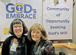 Heather Simon, left, and her mother, Colleen Simon, share smiles as they pose for a photo behind the counter of God&rsquo;s Embrace Coffee Shop, a business that strives to help people with disabilities find their purpose. (Photo by John Shaughnessy)