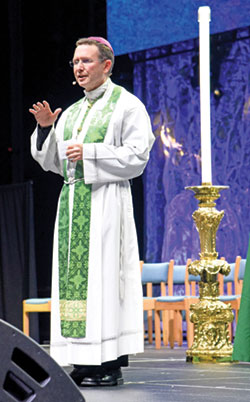 Bishop Andrew H. Cozzens of Crookston, Minn., speaks before the National Catholic Youth Congress&rsquo; closing Mass on Nov. 18 about next summer&rsquo;s National Eucharistic Congress in Indianapolis. (Photo by Sean Gallagher)