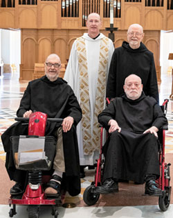Benedictine Father No&euml;l Mueller, left, Benedictine Father Joseph Cox, Benedictine Brother Jacob Grisley and Benedictine Father Ephrem Carr, four of the five Benedictine monks marking significant jubiliees this year at St. Meinrad Archabbey, pose in the Archabbey Church of Our Lady of Einsiedeln in St. Meinrad.  (Photo courtesy of Saint Meinrad Archabbey)