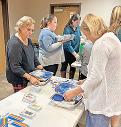 Teachers and staff of St. Matthew the Apostle School in Indianapolis assemble &ldquo;birthday-in-a-box&rdquo; kits for the food pantry at St. Philip Neri School in Indianapolis, a Mother Theodore Catholic Academy, on Dec. 5. (Submitted photo)