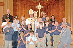 Archbishop Charles C. Thompson poses for a photo with a group from St. Joseph School in Shelbyville after the archdiocese&rsquo;s Catholic Schools Week Mass in SS. Peter and Paul Cathedral on Jan. 31. (Photo by John Shaughnessy)