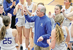 Head coach Dan Wagner shares a moment of joy with the players on the girls&rsquo; varsity basketball team of Bishop Chatard High School in Indianapolis during the 2023-24 season. (Photo courtesy of Angie Tragesser)