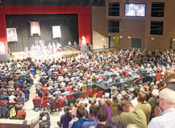 Father Jonathan Meyer celebrates Mass with concelebrating priests on Feb. 17 at East Central High School in St. Leon during the ninth annual E6 Catholic Men&rsquo;s Conference sponsored by All Saints Parish in Dearborn County. More than 1,200 men took part in the event. (Photo by Sean Gallagher)