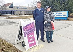 Larry Kunkel, left, and Margie Schmitz serve as Sidewalk Advocates for Life volunteers at the Planned Parenthood facility in Indianapolis, where women go for abortion referrals, birth control, &ldquo;morning after&rdquo; emergency contraception and other services in opposition to the sanctity of life. (Photo by Natalie Hoefer)