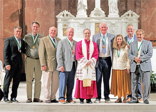 Archbishop Charles C. Thompson poses for a photo with the recipients of the St. John Bosco Award, the highest honor given by the archdiocese&rsquo;s Catholic Youth Organizations. The honorees are Kevin Sowinski, left, Thomas O&rsquo;Gara, Dennis Southerland, Jerry Ross, Edward Tinder, Antoinette Maio Burford, John Gause and Frankie Medvescek. (Submitted photo)