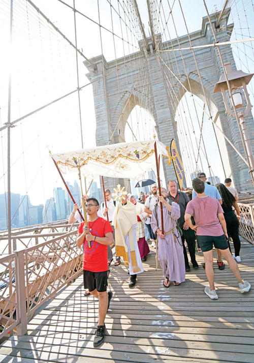 Bishop Robert J. Brennan of Brooklyn, N.Y., carries a monstrance while leading a eucharistic procession across the Brooklyn Bridge to Brooklyn from Manhattan on the National Eucharistic Pilgrimage&rsquo;s St. Elizabeth Ann Seton (East) Route on May 26. (OSV News photo/Gregory A. Shemitz, The Tablet)
