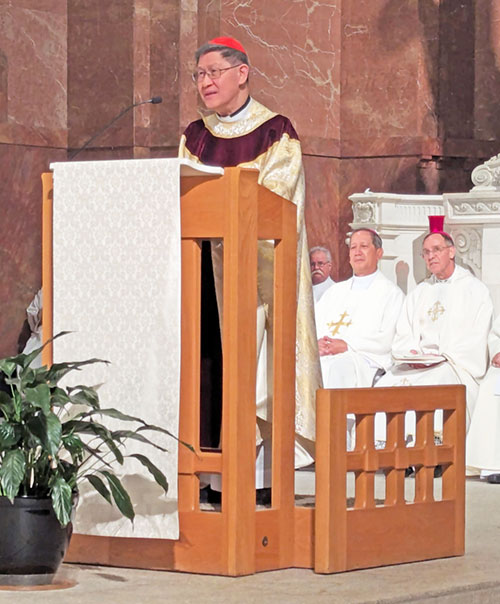Cardinal Antonio Tagle, pro-prefect of the Vatican&rsquo;s Dicastery for the Evangelization of Peoples, preaches during a Mass with 800 Filipino Catholics at SS. Peter and Paul Cathedral in Indianapolis. Six bishops, including Archbishop Charles C. Thompson, right, concelebrated, along with 40 priests. (Photo by Sean Gallagher)