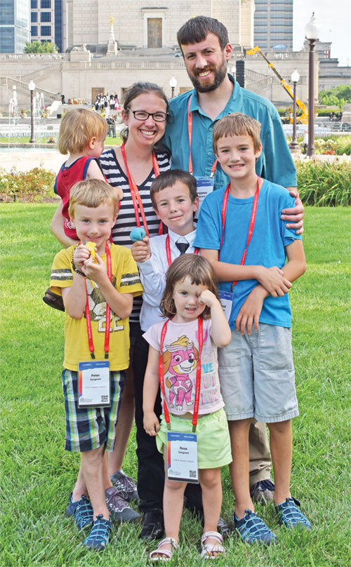 Leigh and Benjamin Sargeant and their five children&mdash;Rose in front with Peter (left), Dominic and Samuel behind her, and Isaiah, held by Leigh&mdash;pose in Memorial Plaza in Indianapolis on July 20 after worshipping the Blessed Sacrament with more than 50,000 people during the National Eucharistic Congress. The day marked the couple&rsquo;s 11th wedding anniversary. (Photo by Natalie Hoefer)