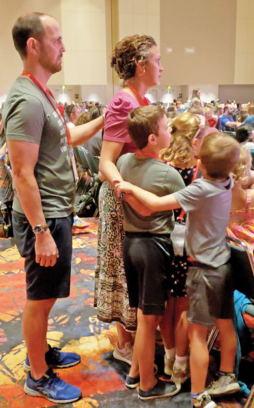A family lays their hands on each other in prayer as part of a family-focused session on July 19 during the National Eucharistic Congress in Indianapolis. (Photo by Natalie Hoefer)
