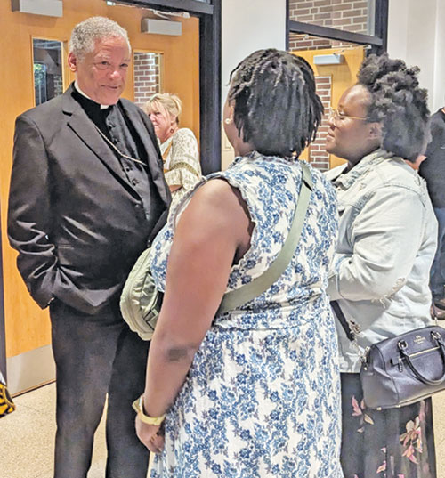 Retired Bishop Joseph N. Perry of Chicago, postulator for Father Augustus Tolton&rsquo;s sainthood cause, speaks with Tolton film viewers outside Marian University Theater in Indianapolis on July 16. (Photo by Ann Margaret Lewis)