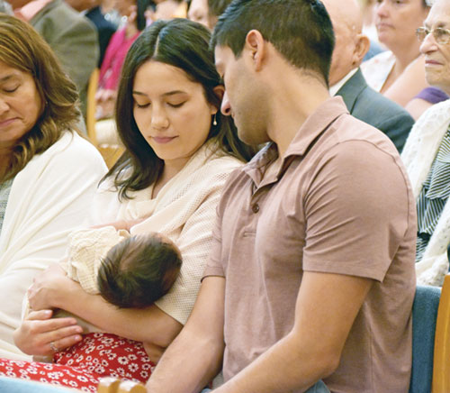 Maria and Anthony Neari, members of St. John the Evangelist Parish in Indianapolis, look lovingly at their son Salvatore during the archdiocese&rsquo;s 40th annual Wedding Anniversary Mass in SS. Peter and Paul Cathedral in Indianapolis on Aug. 25. (Photo by Natalie Hoefer) 