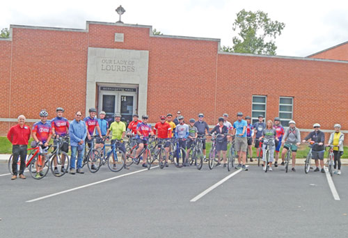 A group of cyclists taking part in the annual &ldquo;Biking for Babies&rdquo; event poses on Sept. 7 in the parking lot of Our Lady of Lourdes Parish in Indianapolis. (Photo by Mike Krokos)