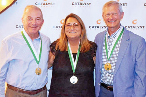 Tracy Cooper, left, Leisa Roll and Bob Naville show their joy in receiving the St. John Bosco Medal, the highest honor that the archdiocese’s Catholic Youth Organization awards its volunteers. (Submitted photo)
