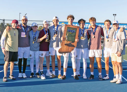 The players and coaches of the boys&rsquo; tennis team of Brebeuf Jesuit Preparatory School in Indianapolis pose with their Indiana State High School Athletic Association state championship trophy after their thrilling victory over the team from Center Grove High School on Oct. 19 in Indianapolis. (Photo courtesy of Mike Hoffbauer)