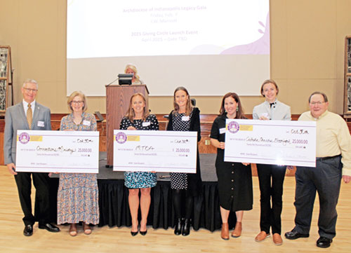 Representatives of the inaugural Catholic Women&rsquo;s Giving Circle (CWGC) grant-winning archdiocesan agencies and CWGC members pose on Oct. 30 during an awards dinner at the Archbishop Edward T. O&rsquo;Meara Catholic Center in Indianapolis. They are, from left, Deacon John Cord, coordinator of the archdiocese&rsquo;s Corrections Ministry; Kathy Laudick of CWGC; Lora Prange and Kacy Naab of Mother Theodore Catholic Academies; Elisabeth Williams of CWGC; and Emily Cook and Dennis Craig of Catholic Charities in Bloomington. (Photos by Jennifer Lindberg) 