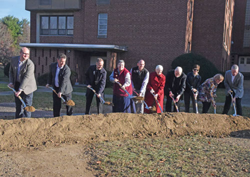 The Benedictine sisters of Our Lady of Grace Monastery in Beech Grove broke ground on Nov. 24 on a new monastery. Shoveling the dirt are, from left, Brian Ziolkowski and Michael Egan of the Browning Day architectural firm, Archbishop Charles C. Thompson, Benedictine Sister Julie Sewell, Beech Grove Mayor James Coffman, Benedictine Sister Carol Falkner, Father James Farrell, Connie Lund and Colleen Kenney of the monastery&rsquo;s Lay Board of Advisers, and Phil Kenney of F. A. Wilhelm Construction. (Photo by Sean Gallagher)