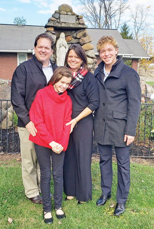 Joshua, left, Kathryn, Laura and Levi Marszalek, members of St. Gabriel Parish in Connersville, pose in front of the parish&rsquo;s Marian grotto on Nov. 24. The family&rsquo;s faith has been enhanced through Kathryn&rsquo;s early diagnosis of Alternating Hemiplegia of Children, or AHC, an extremely rare neurological disorder. (Photo by Natalie Hoefer)