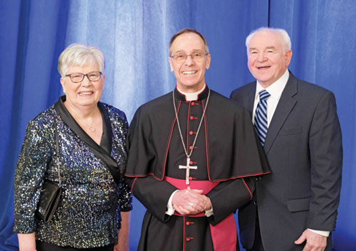 Archbishop Charles C. Thompson poses for a photo with Laura Jo and Glenn Tebbe, recipients of the archdiocese&rsquo;s 2025 Legacy Award during the Legacy Gala in Indianapolis on Feb. 7. (Photo courtesy of Denis Kelly)
