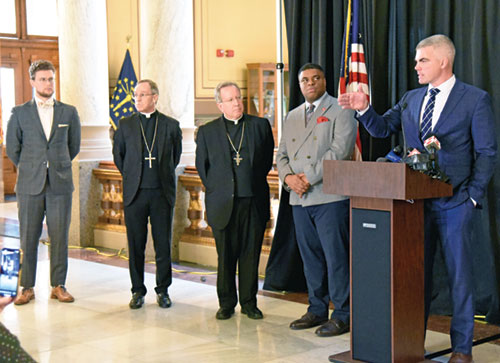 Rep. Bob Morris (R-Fort Wayne), right, addresses the media at a Feb. 3 press conference at the&nbsp;Indiana Statehouse in Indianapolis calling for repeal of the death penalty in the state. He was joined by Alexander Mingus, left, executive director of the Indiana Catholic Conference; Archbishop Charles C. Thompson of Indianapolis; Bishop Robert J. McClory of the Diocese of Gary, Ind.; and Demetrius Minor, national manager of Conservatives Concerned About the Death Penalty. (Photo by Sean Gallagher)