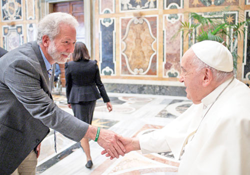 John Mundell, a member of Our Lady of Lourdes Parish in Indianapolis, greets Pope Francis during a June 2024 meeting at the Vatican. He serves as the global director of the Vatican&rsquo;s Laudato Si&rsquo; Action Platform. (Submitted photo)