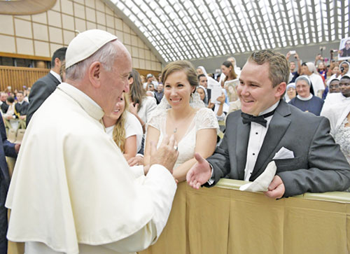 Elisabeth and Scott Williams smile in complete joy as they meet Pope Francis at the Vatican on Aug. 3, 2016. Married on May 28 in that year, the couple later traveled to Rome after they learned about the long-standing tradition of popes offering a blessing to newlyweds. (Photo courtesy of L&rsquo;Osservatore Romano)