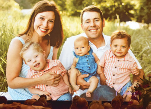 A photo of the Cochran family&mdash;Alyssa, left, Oliver, Hazel May, Cory and Atticus&mdash;is displayed during a gala for St. Elizabeth Catholic Charities in New Albany on April 10. Alyssa and Cory, who adopted Atticus through the agency&rsquo;s Adoption Bridges of Kentuckiana, spoke at the event. (Photo by Natalie Hoefer) 