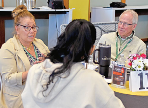 Jeff McQueen, right, a volunteer for several ministries at St. Susanna Parish in Plainfield, listens to Veronica Castillo-Rogers, left, director of youth faith formation and teen ministries at St. Patrick Parish in Terre Haute, on April 8 during a workshop on the U.S. Conference of Catholic Bishops&rsquo; &ldquo;Listen Teach Send&rdquo; document. Written for ministries of youths and young adults, the listen-teach-send method also serves as a dynamic model for evangelization. (Photo by Natalie Hoefer)