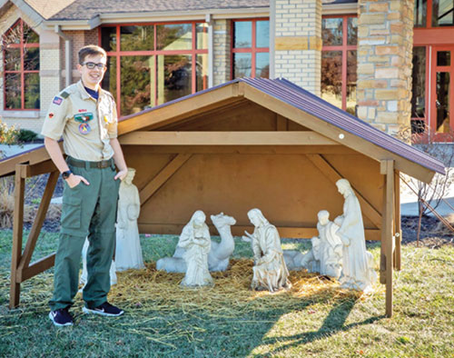 Michael Dexter, a member of Nativity of Our Lord Jesus Christ Parish in Indianapolis, poses by his faith community&rsquo;s outdoor Nativity set. He created a new lightweight stable for it as part of an Eagle Scout project he completed. (Submitted photo)