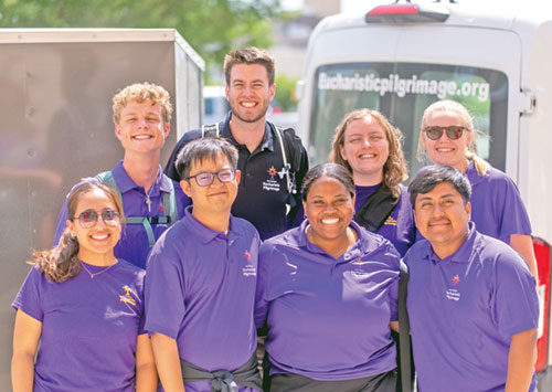 The young adult pilgrims who recently made the 3,300-mile National Eucharistic Pilgrimage from Indianapolis to Los Angeles show their joy for the journey. In the front row are Leslie Reyes-Hernandez, left, Ace Acu&ntilde;a, Cheyenne Johnson and Johnathan Silvino Hernandez. In the back row are Stephen Fuhrmann, left, Charlie McCullough, Rachel Levy and Frances Webber. (Photo contributed by the National Eucharistic Congress)