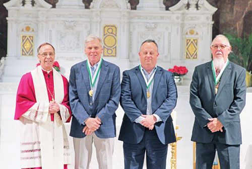 Archbishop Charles C. Thompson shares a moment of celebration with John Bannister, left, Kevin Kirkhoff and Randall Herrman, this year&rsquo;s recipients of the St. John Bosco Medal, the highest honor the archdiocese&rsquo;s Catholic Youth Organization gives an individual. (Photo courtesy of Zoe Hawkins)
