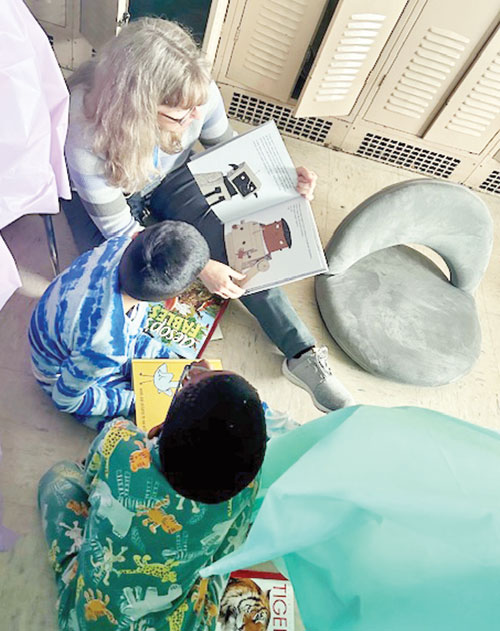 Pam Breedlove, a literacy coach at Central Catholic School in Indianapolis, reads to third-grade students during Camp Read A Lot, a celebration of the school&rsquo;s dramatic improvement in student literacy, with a 51.7 percentage-point increase in its Indiana Reading Evaluation and Determination (IREAD) testing in the 2024-25 school year. (Submitted photo)
