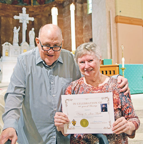 After the archdiocese&rsquo;s annual Wedding Anniversary Mass at SS. Peter and Paul Cathedral in Indianapolis on Aug. 24, Jesse and Nancy Wadle smile with a copy of a certificate honoring their 60th anniversary. See more wedding anniversaries on pages 9 and 10. (Photo by Natalie Hoefer)