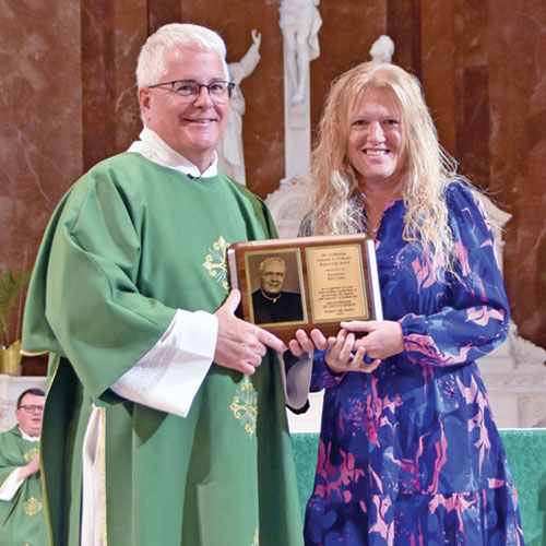 Annissa Kellum of St. Michael Parish in Bradford receives the archdiocese&rsquo;s Archbishop O&rsquo;Meara Respect Life Award from Deacon Thomas Hosty during the archdiocesan Respect Life Mass at SS. Peter and Paul Cathedral in Indianapolis on Oct. 5. October is Respect Life Month in the Church in the United States. (Photo by Natalie Hoefer)