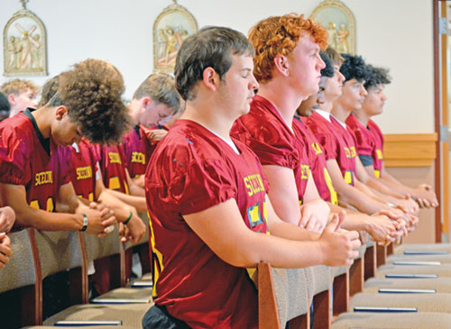 Members of the football team of Father Thomas Scecina Memorial High School in Indianapolis show their reverence and solidarity during a pre-game Mass in the school&rsquo;s chapel on Sept. 19. (Photo courtesy of Katie Nelson)