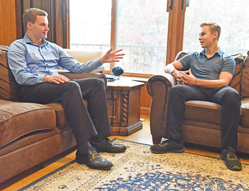 Seminarians Dominic Pavey, left, and Max Ecoff chat on Oct. 21 at Bishop Simon Brut&eacute; Seminary in Indianapolis where they are respectively in their second and first years of priestly formation. Both members of Our Lady of the Most Holy Rosary Parish in Indianapolis, they noted that seeing happy and holy priests and seminarians helped them in their discernment of a possible vocation to the priesthood. (Photo by Sean Gallagher)