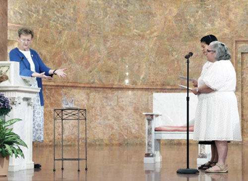 Providence Sister Dawn Tomaszewski, general superior of the Sisters of Providence of Saint Mary-of-the-Woods in St. Mary-of-the-Woods, left, welcomes Ann Duong, second from right, and Mait&eacute; Rodriguez-Mora as novices in the community during an Aug. 24 ceremony in the Church of the Immaculate Conception at the community&rsquo;s motherhouse. (Submitted photo)