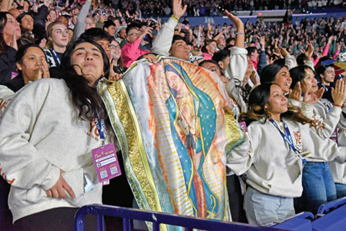 National Catholic Youth Conference participants hold up a banner of Our Lady of&nbsp;Guadalupe&nbsp;while celebrating after the end of the event&rsquo;s closing Mass on Nov. 22 in Lucas Oil Stadium in Indianapolis. (Photo by Sean Gallagher)