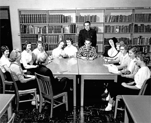 Students at a former Catholic high school in Terre Haute appear in this photo with Fr. Joseph Beechem, principal. A member of the Sisters of Providence, who taught at the school, also appears in the group. This Vigo County high school operated from 1953-1977. Prior to 1953, there was a small Catholic high school for girls in Terre Haute, but no option for boys.