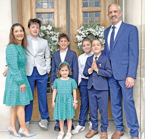 Gabrielle and Roger Neal pose for a family photo with their five children outside Immaculate Heart of Mary Church in Indianapolis, the family&rsquo;s parish church. The children are Daniel, left, Matthew, Stella, Noah and George. Gabrielle is the new director of Catholic Charities Indianapolis. (Submitted photo)
