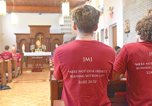 Bishop Brut&eacute; Days participants kneel in prayer during eucharistic adoration on July 14 in the chapel of Bishop Simon Brut&eacute; College Seminary in Indianapolis. (Photo by Sean Gallagher)